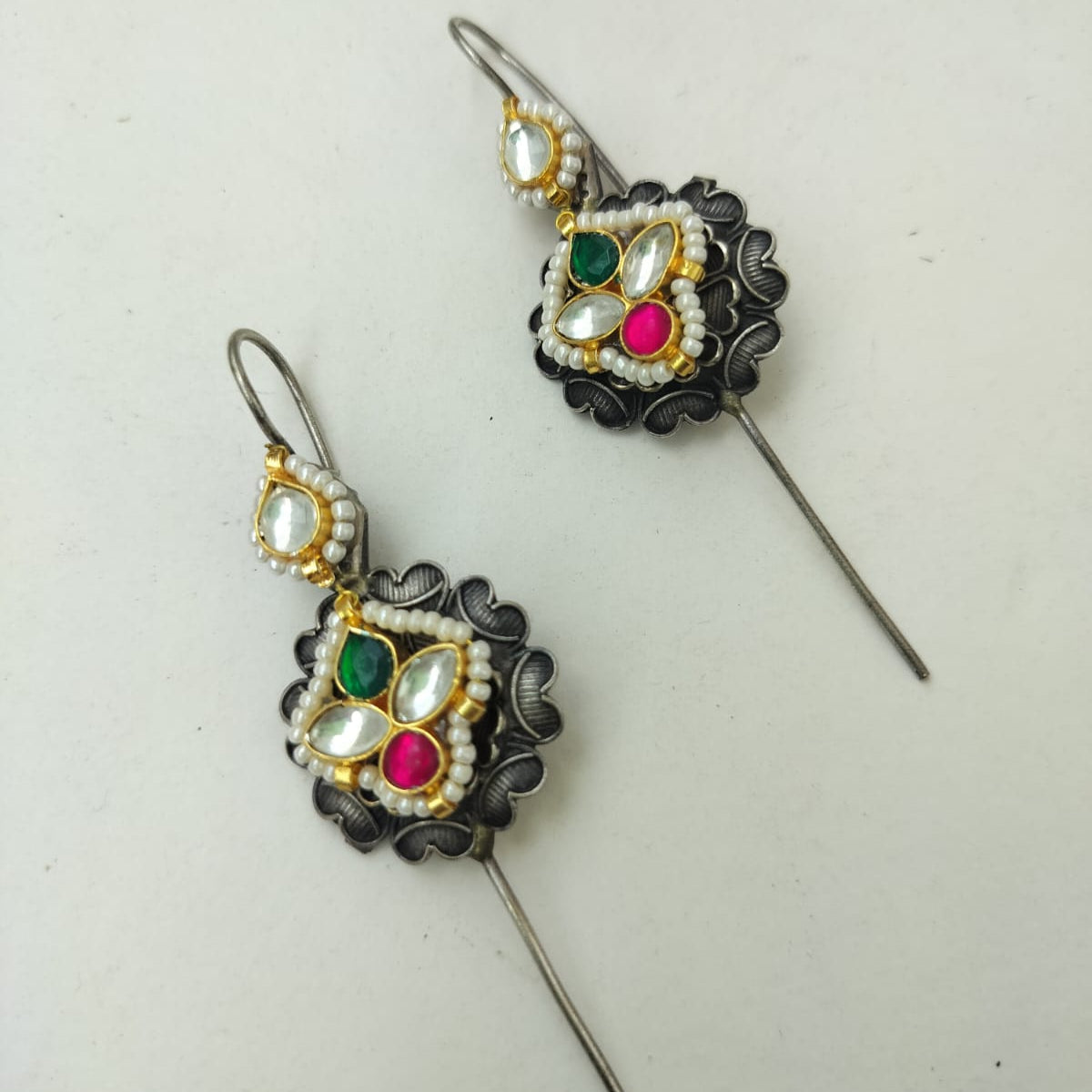 Decorative earrings with gemstones on a white background