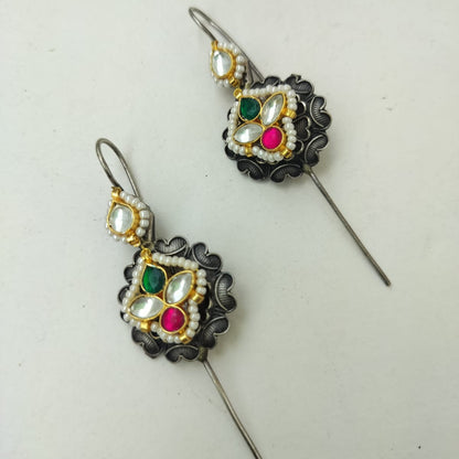 Decorative earrings with gemstones on a white background
