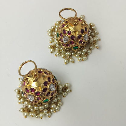 Pair of gold earrings with gemstones on a white background